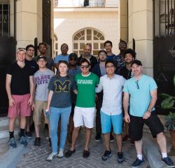 A group of students standing outside of a gate