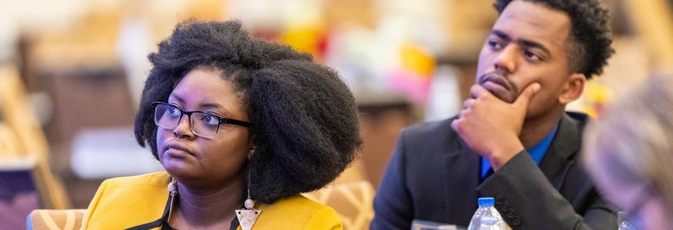 Two students intently listening to a lecture