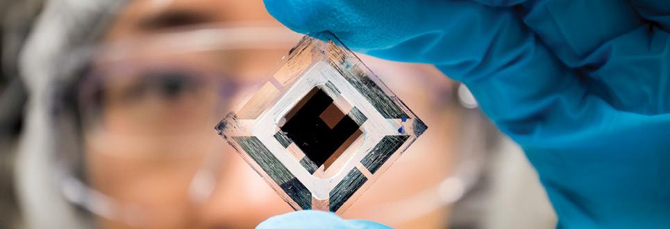 A student holds up a computer chip